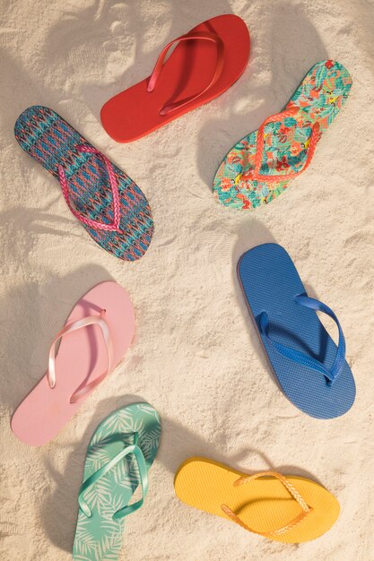 Different color flip flops on beach