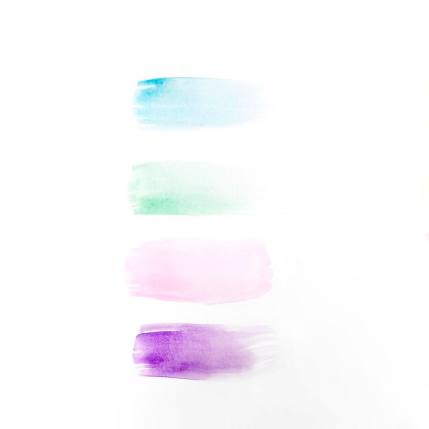 Free photo different colored brushstrokes on table