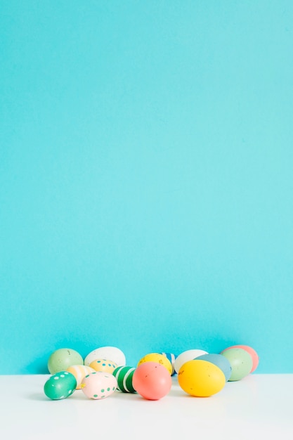 Different colored Easter eggs on table