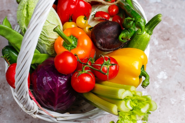 Different colorful fresh vegetables on concrete surface