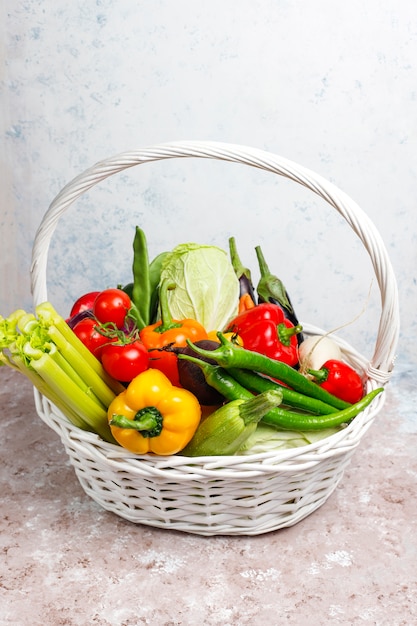 Different colorful fresh vegetables on concrete surface