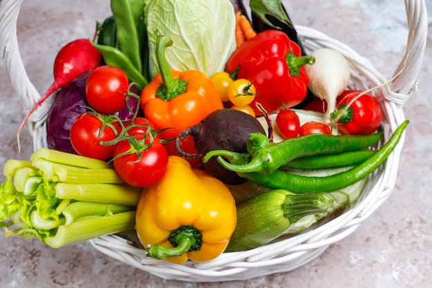 Different colorful fresh vegetables on concrete surface