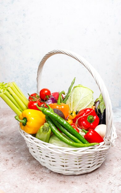 Different colorful fresh vegetables on concrete surface