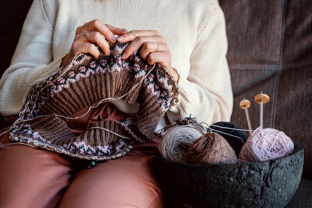 Different colors of threads and sewing accessories in a basket