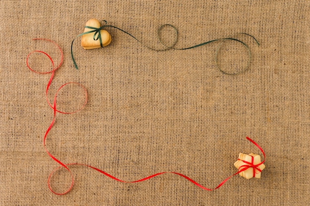 Different cookies with ribbons on table