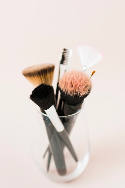 Different cosmetic brushes in clear glass