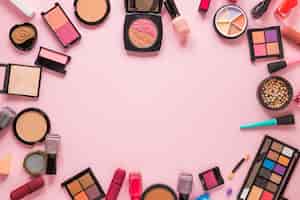 Free photo different cosmetics types scattered on pink table