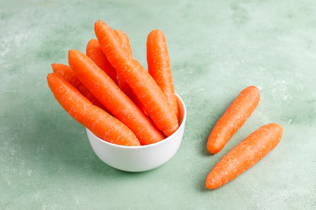 Different cuts of carrot in bowls.