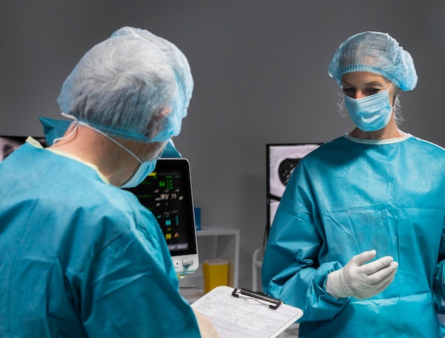 Different doctors doing a surgical procedure on a patient