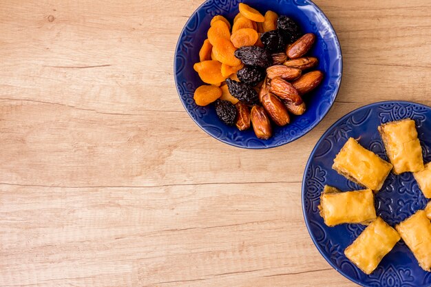 Different dried fruits with eastern sweets on plate