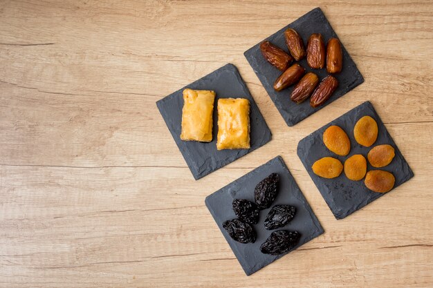 Different dried fruits with eastern sweets on table