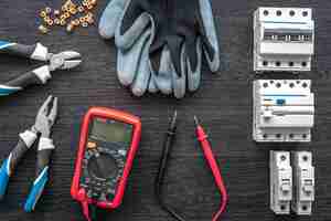 Free photo different electrical tools on wooden background flat lay