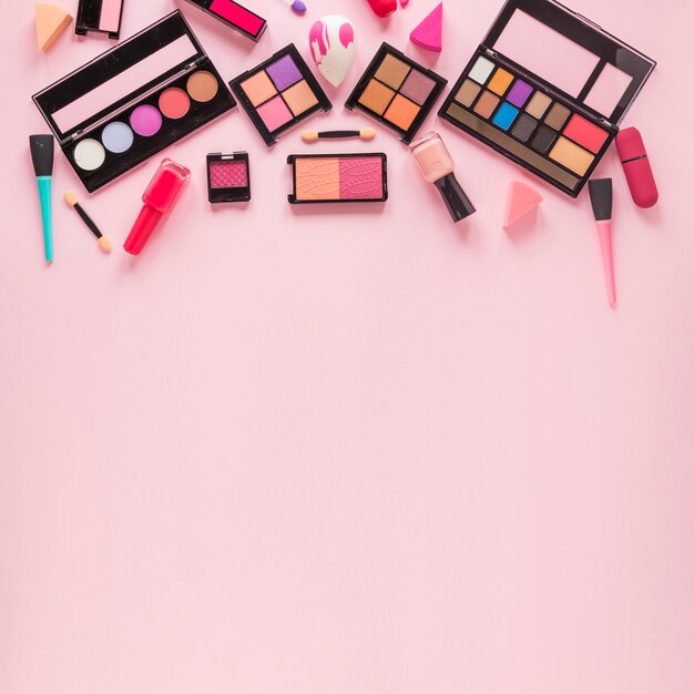 Different eye shadows with nail polish on table