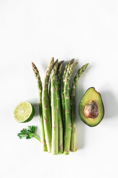 Different fresh green vegetables on a white background Food delivery The concept of raw food Top view