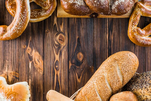 Different freshly baked bread on the wooden background