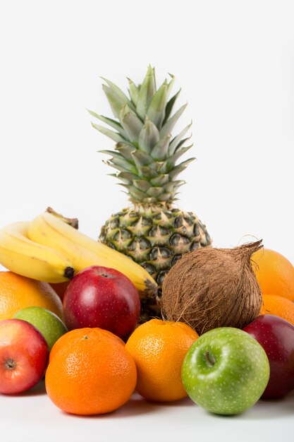 Different fruits ripe juicy whole isolated on a white floor