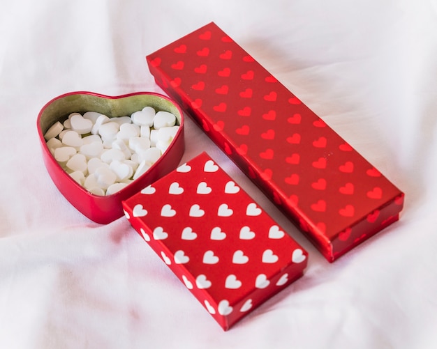 Different gift boxes with hearts on table 