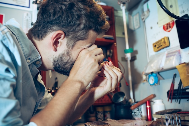 Different goldsmiths tools on the jewelry workplace. Jeweler at work in jewelry.