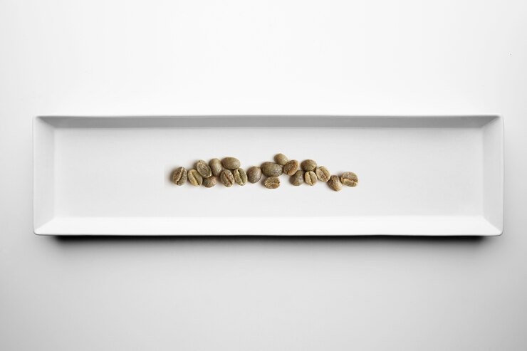 Free Photo different grades of artisan professional roasting coffee isolated on white plate, top view