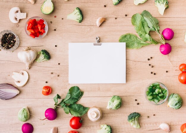 Different kind of fresh vegetables with blank white paper attach with paperclip