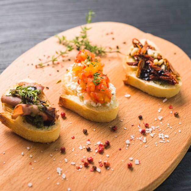 Different kinds of colorful sandwiches on chopping board