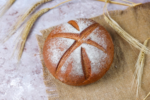 Different kinds of fresh bread as background, top view