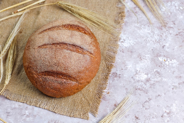 Different kinds of fresh bread as background, top view