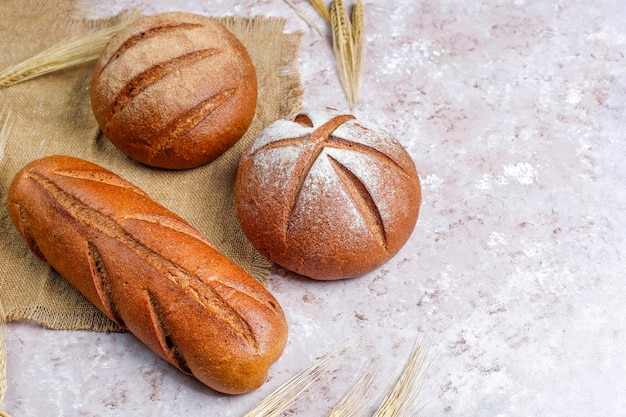 Different kinds of fresh bread as background