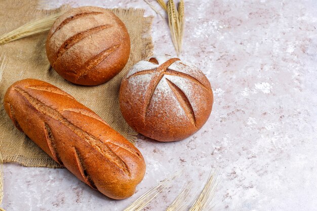 Different kinds of fresh bread as background