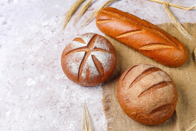 Different kinds of fresh bread as background