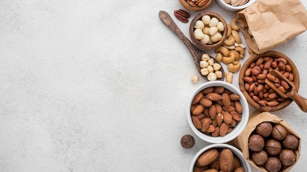 Different kinds of nuts in bowls copy space