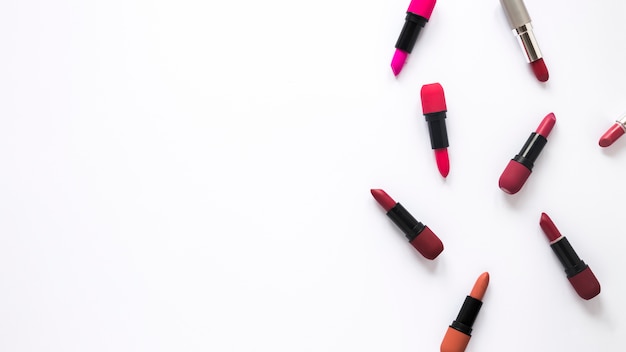 Free photo different lipsticks scattered on table