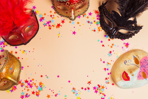 Different masks and stars on table