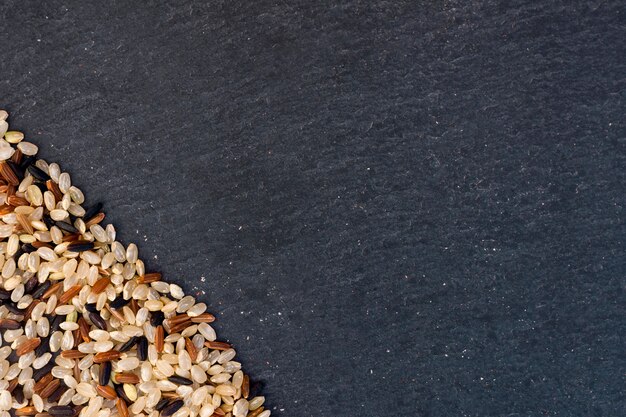 Different rice grains scattered on table