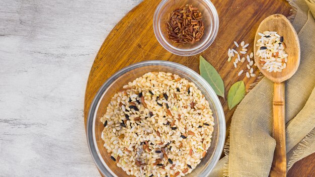 Different rice types in bowls on light table