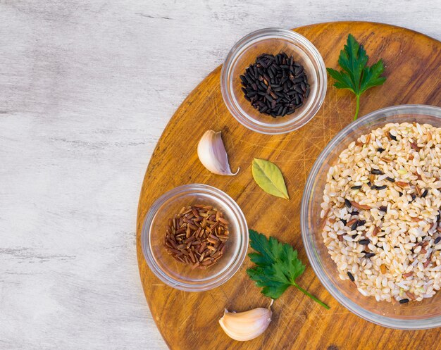 Different rice types in bowls on table 