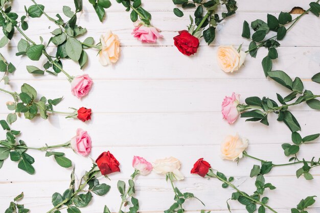 Different roses on wooden table