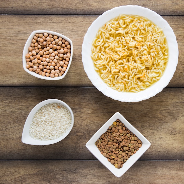 Different seeds on wooden background