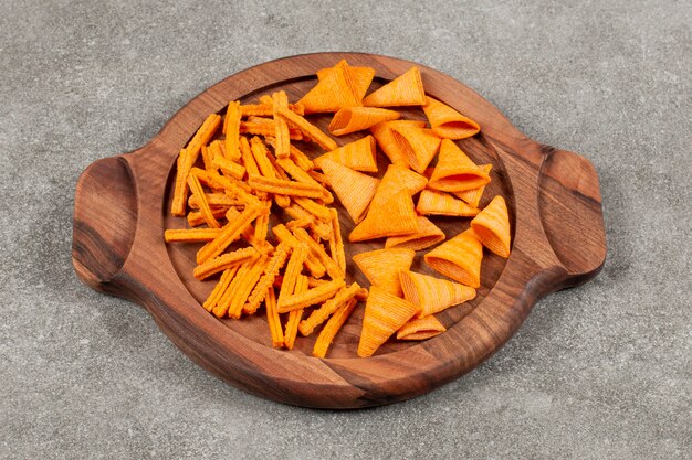 Different shape chips on wooden board over grey