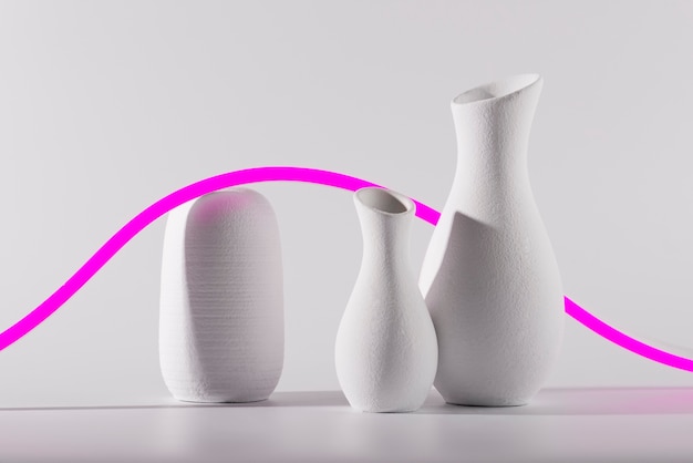 Different shaped vases and pink line