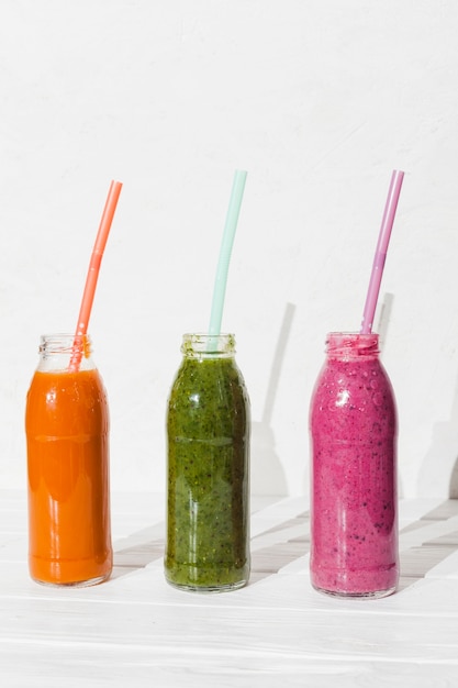 Different smoothies in bottles