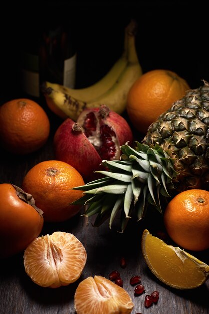 different tropical fruits on a wooden surface
