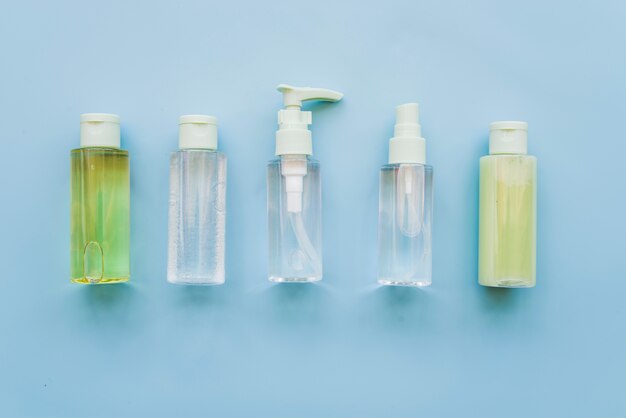 Different type of aloevera spray bottles on blue background