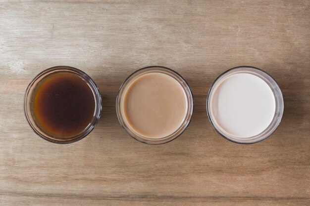 Different type of beverage on wooden texture backdrop