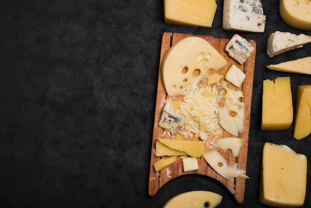 Different type of cheese on black background