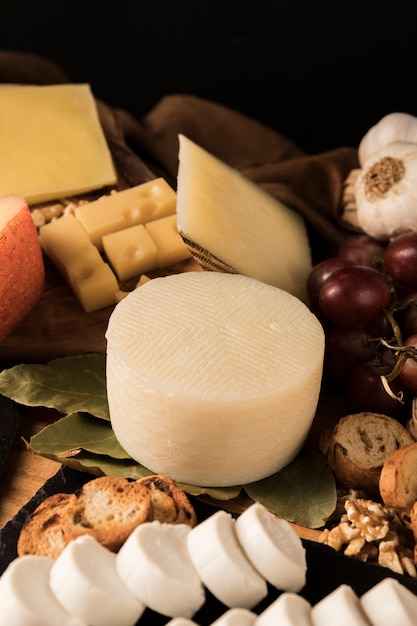 Different type of cheeses and ingredient on table
