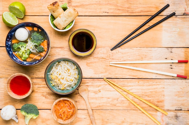 Free photo different type of chopsticks with thai traditional delicious food on wooden desk