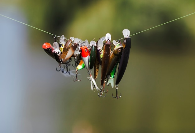 Different type of fish lure hanging on fishing line
