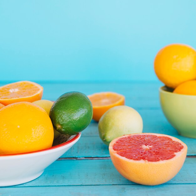 Different type of healthy citrus fruits on wooden desk