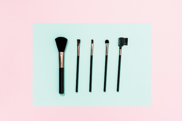 Different type of makeup brushes on dual background
